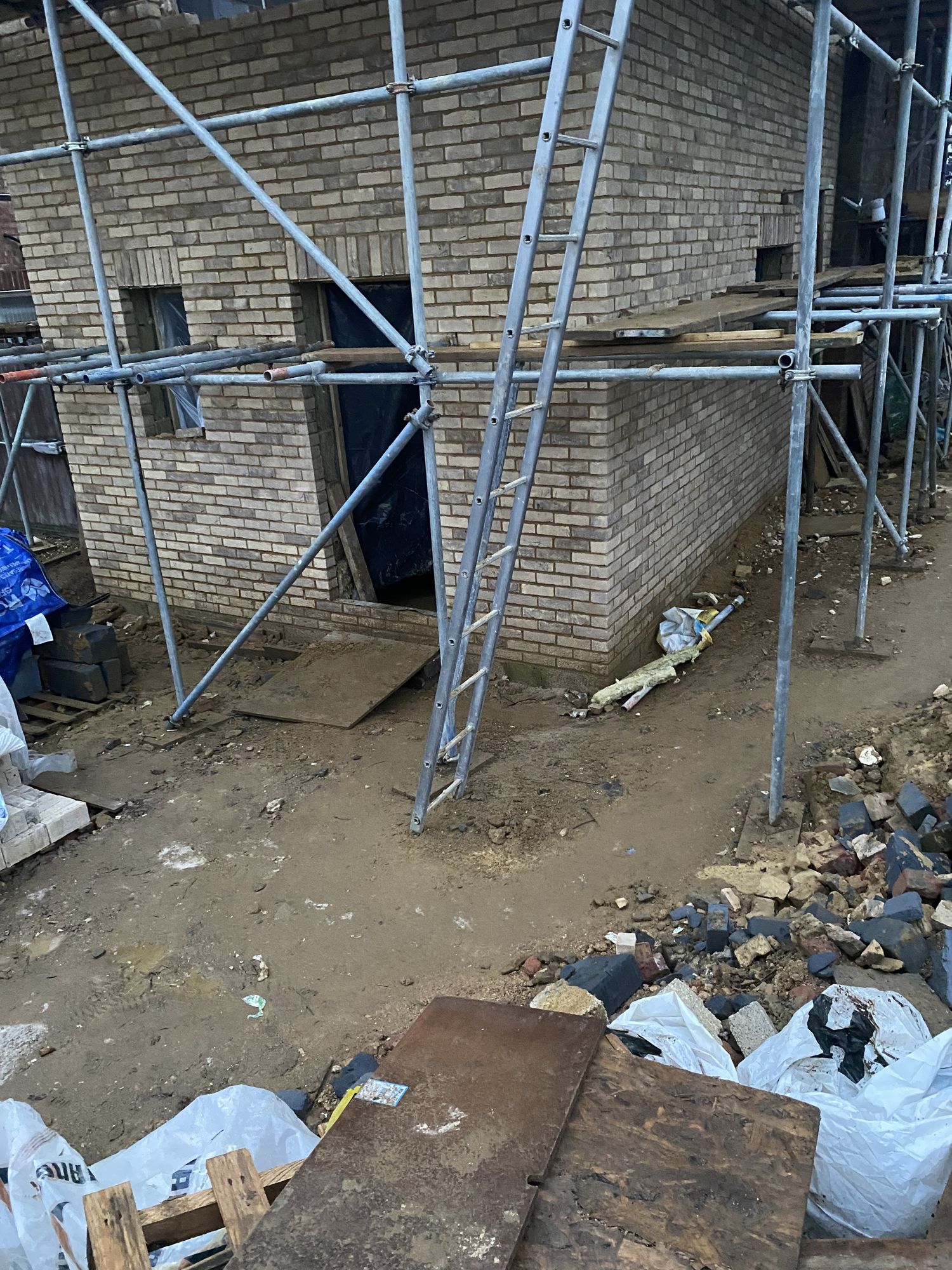 Single-storey buff brick extension going up